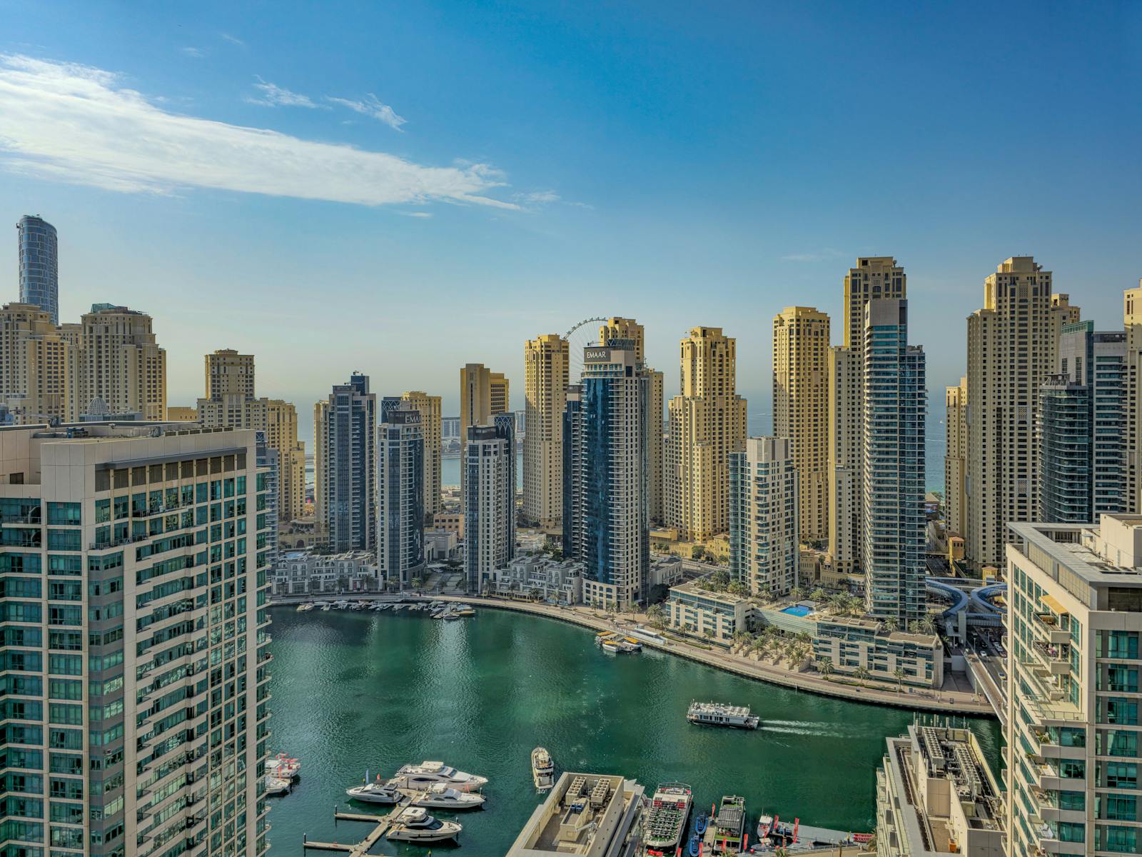 An elevated view over Dubai Marina lagoon, towers and yachts