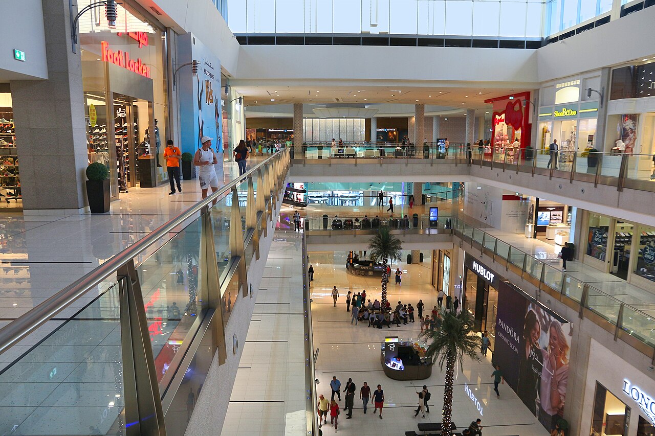 Shopping mall interior with palm trees